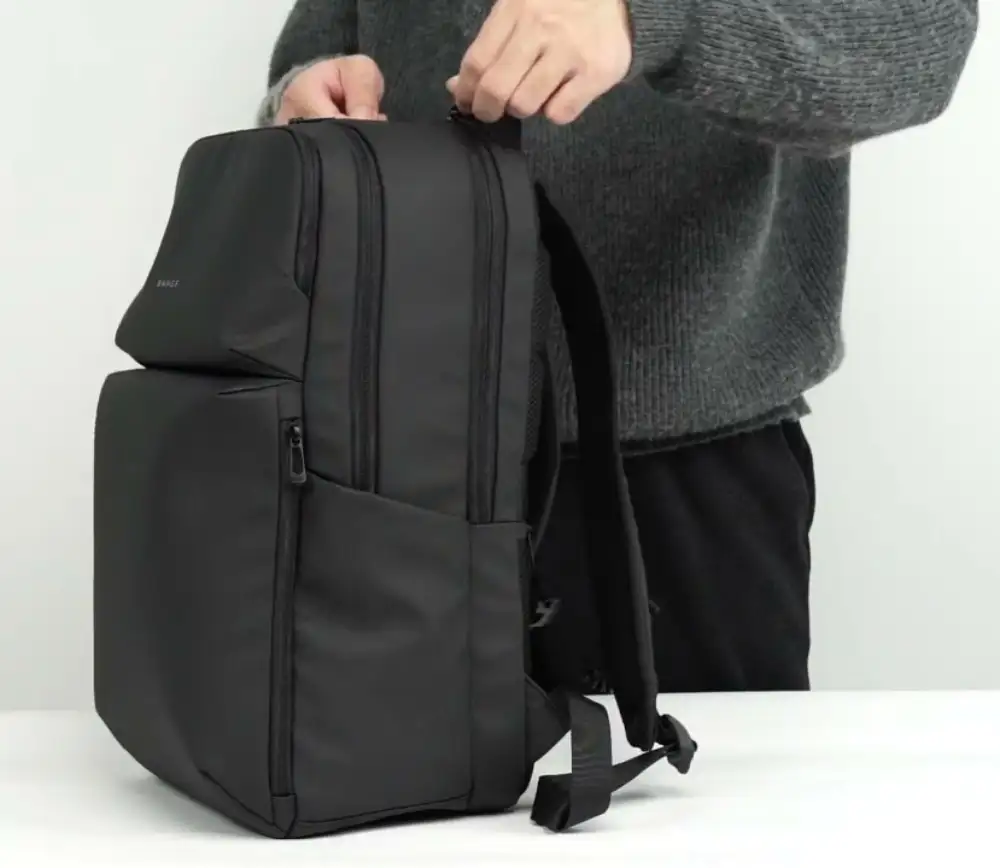A close-up of the Bange 3065's interior, highlighting the multiple spacious compartments and a padded sleeve for a 15.6-inch laptop