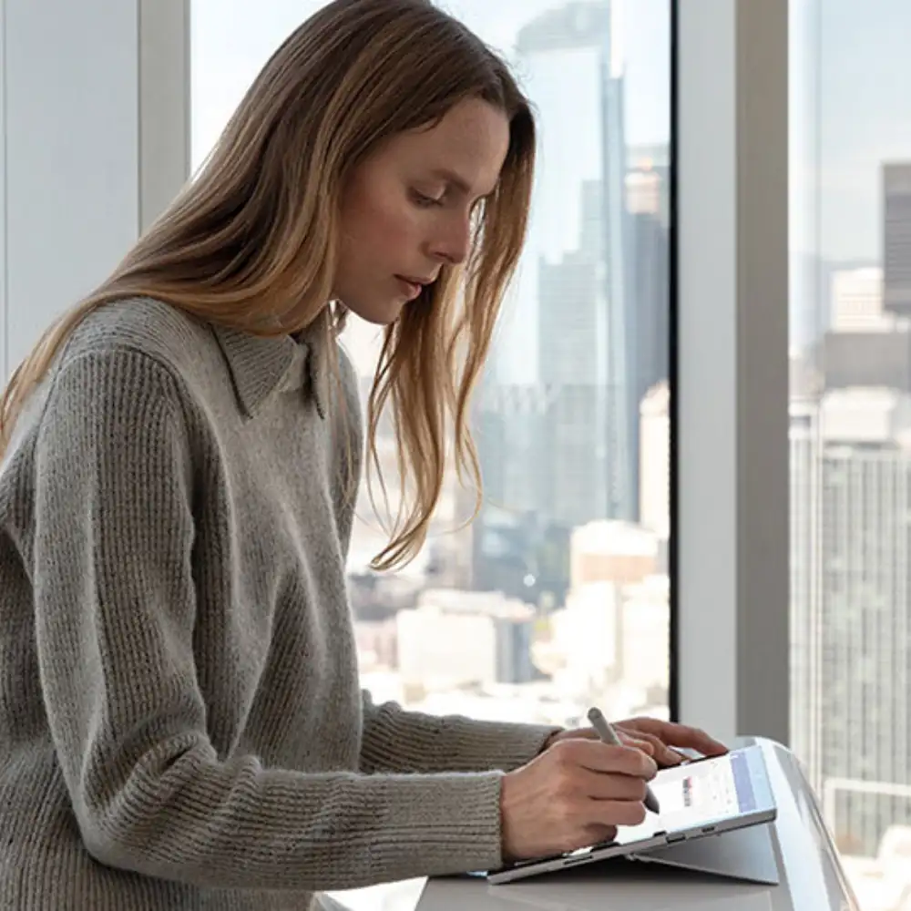 A lifestyle image of the Surface Pen in use with a Surface Pro tablet,