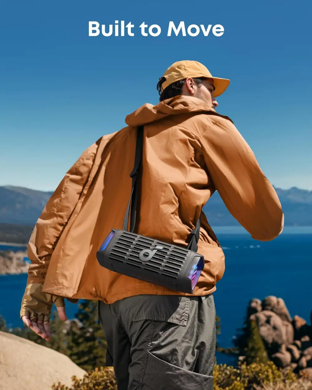 Anker Soundcore Boom 3i Portable Speaker being carried outdoors with a strap