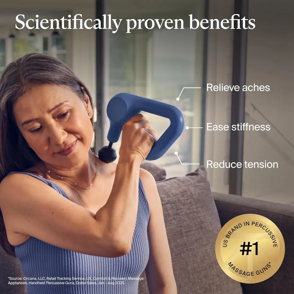 Woman using the TheraGun Relief handheld percussion massage gun on her shoulder to relieve aches, ease stiffness, and reduce muscle tension with scientifically proven benefits.